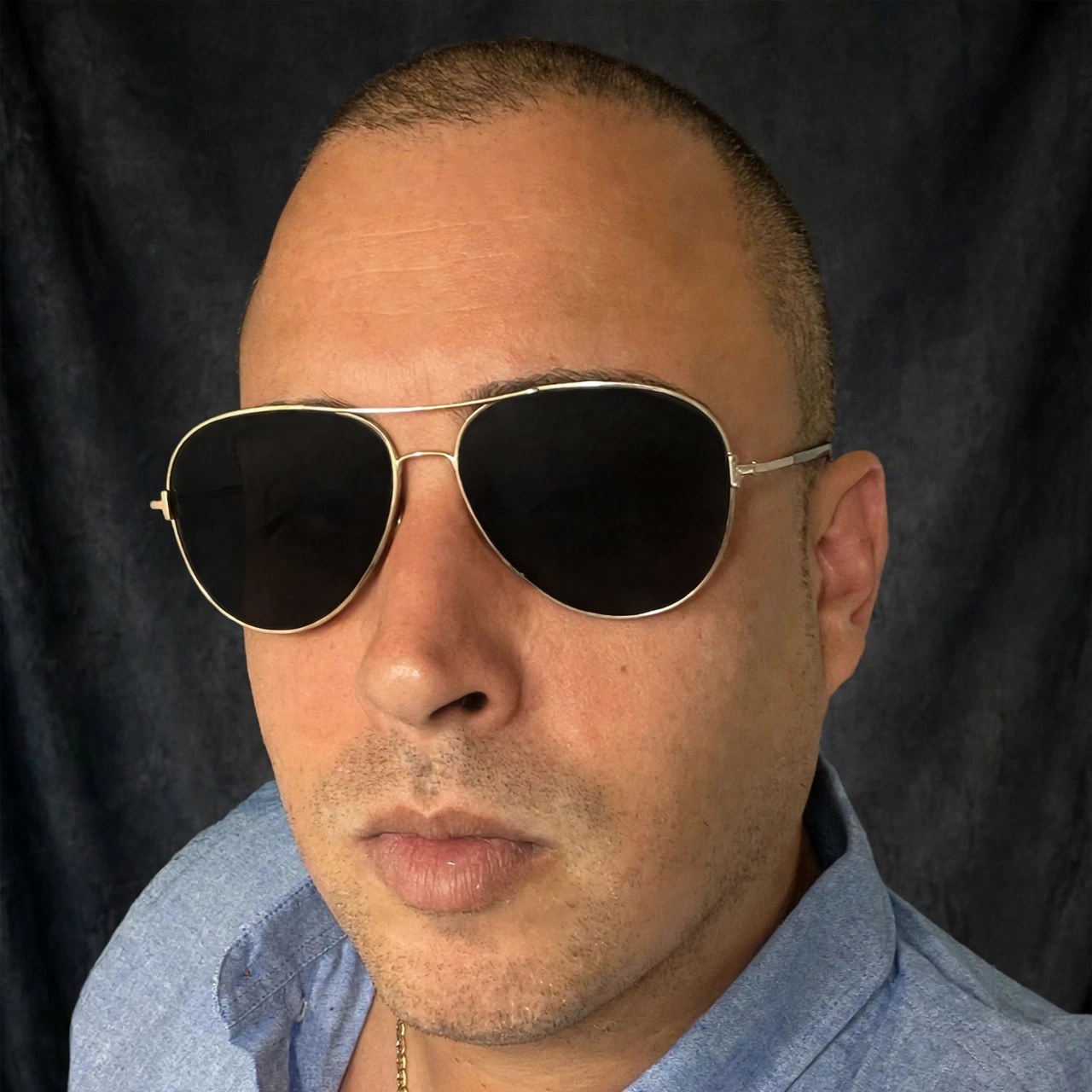 Messy Jordan press portrait in gold aviator sunglasses